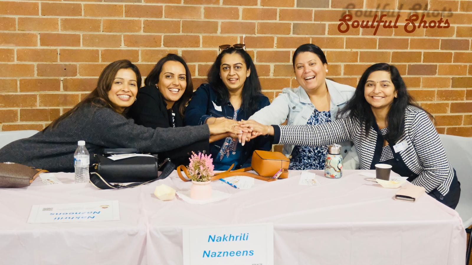 Guests joining hands together at a Sydney Queens event